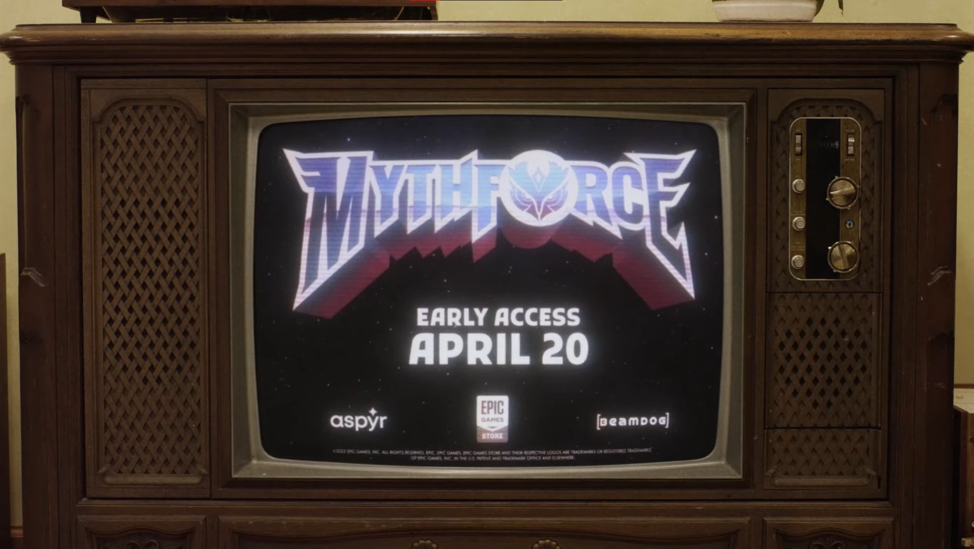 Screenshot from trailer. An old TV displays the MythForce logo, studio icons, and the release date message: Early Access April 20.